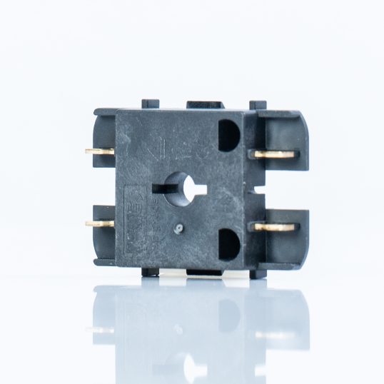 Injection moulding as the basis for high-quality hybrid components, Smybol image. Black plastic part with metal inlay on a white background.