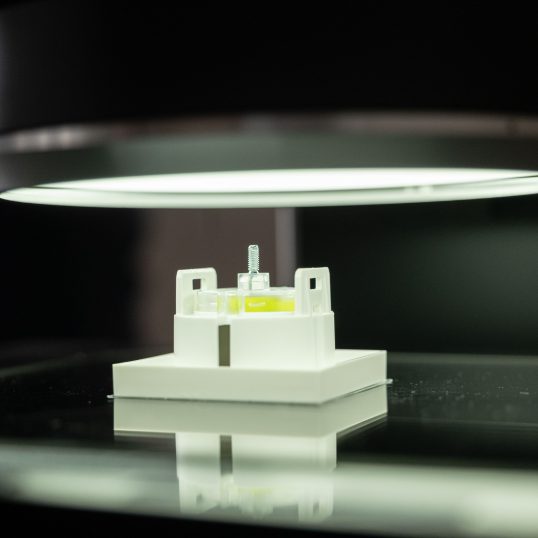 Family business and technology: A measuring device that measures a plastic component.